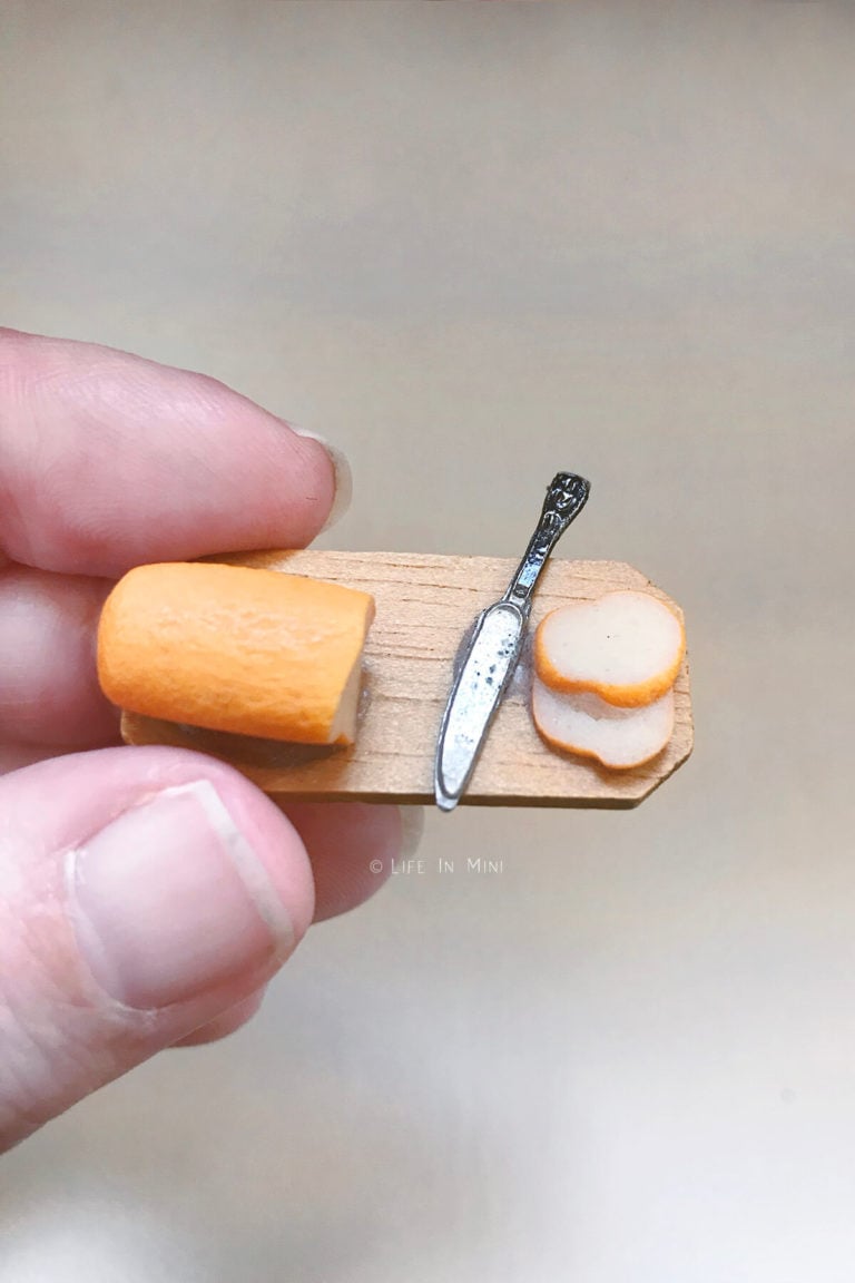 Mini wood board with mini bread loaf, knife and slices of white bread
