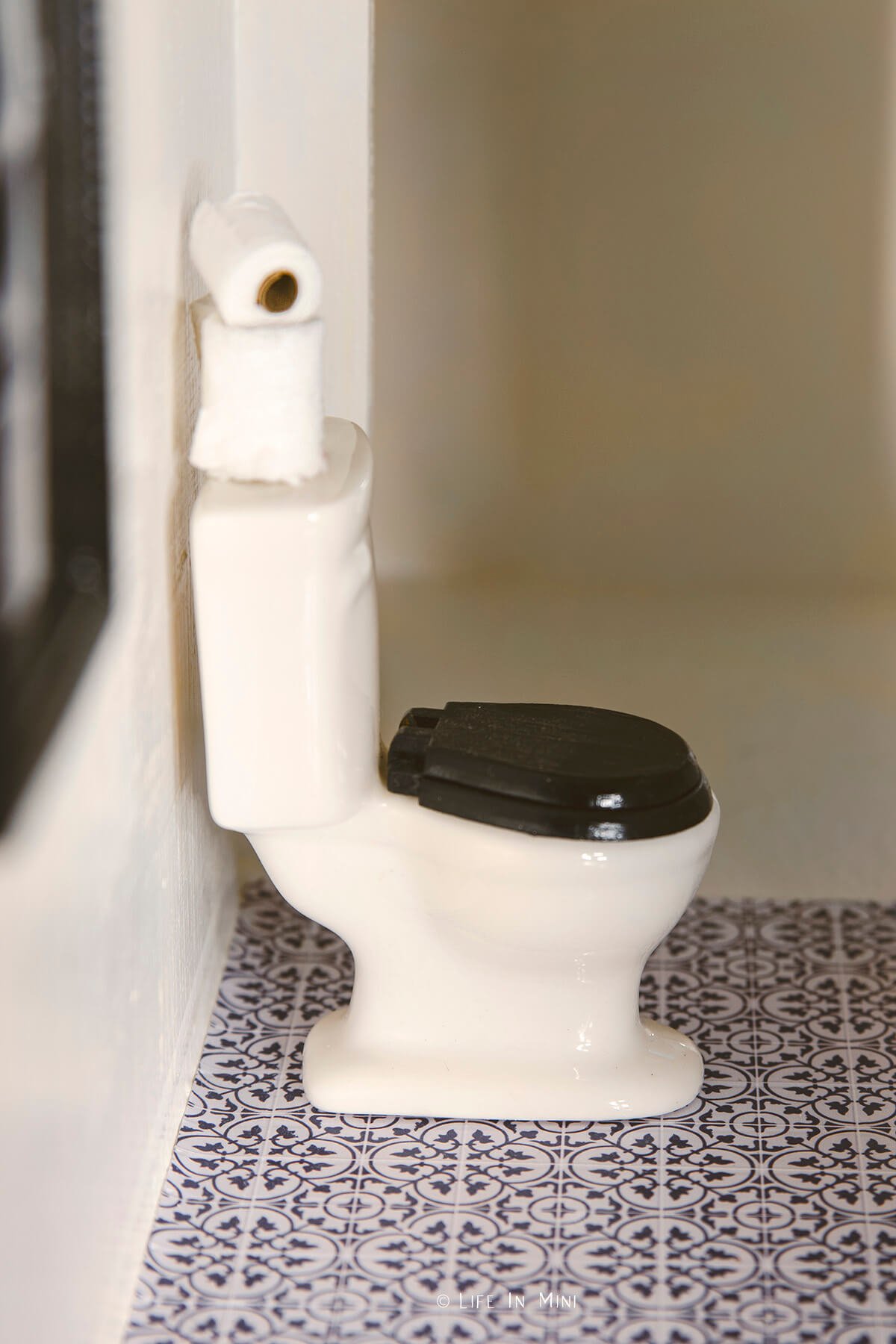 Miniature toilet with paper tile flooring for dollhouse bathroom