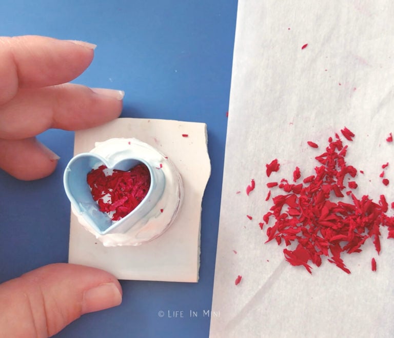 Using a small heart cutter to form the shape to make miniature clay crumb top on a miniature cake
