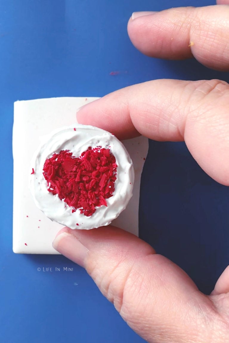 Mini heart made with mini clay crumbs on a miniature cake