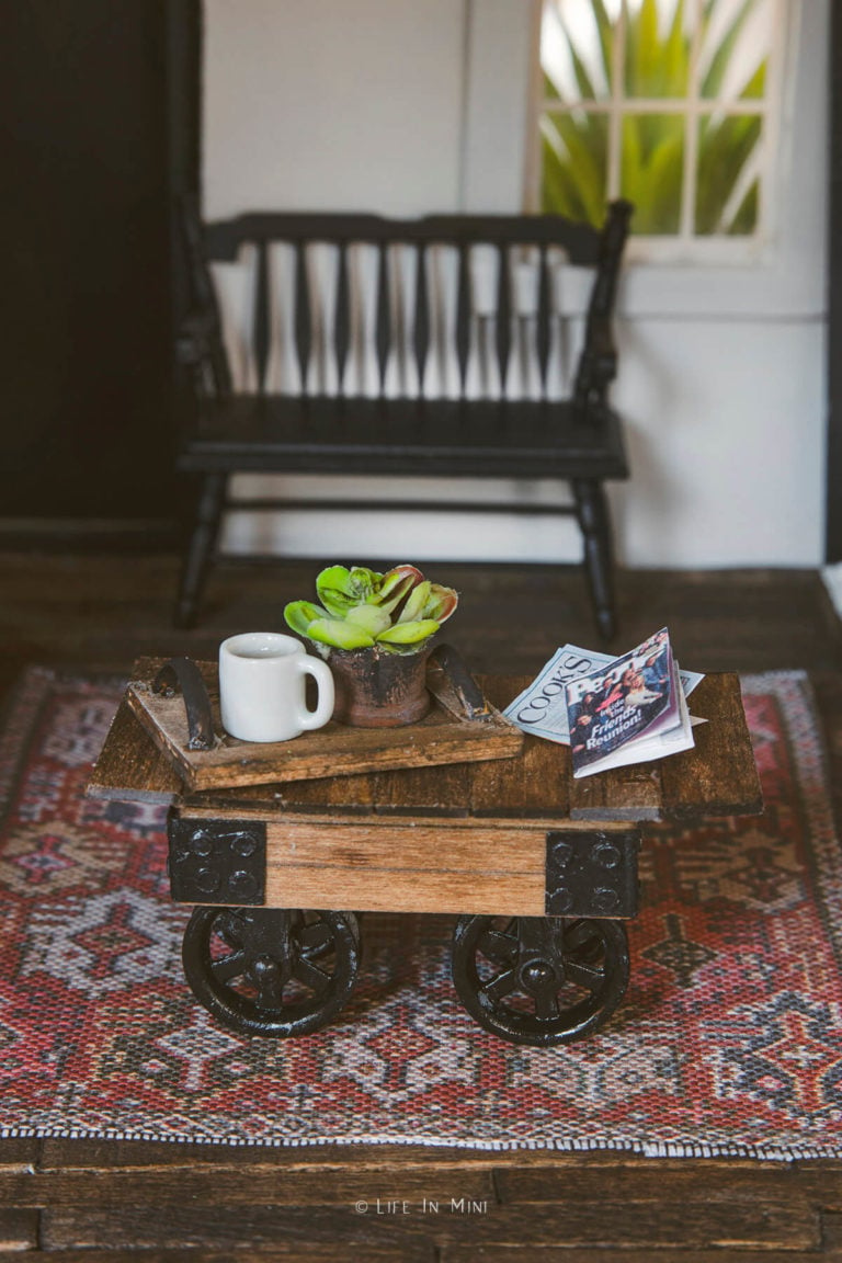 Side view of a miniature coffee table with pulley wheels