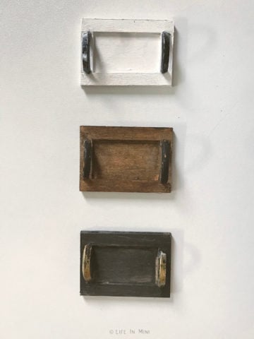 A white, brown and black miniature wooden tray