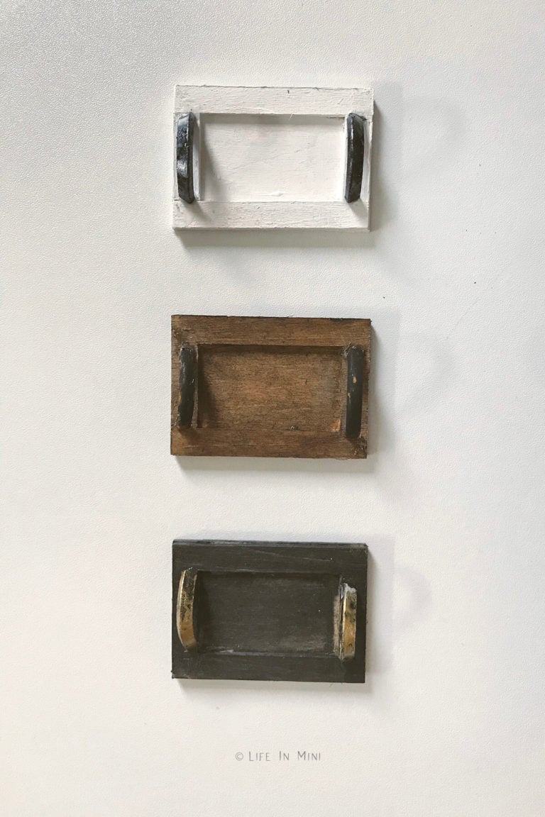 A white, brown and black miniature wooden tray