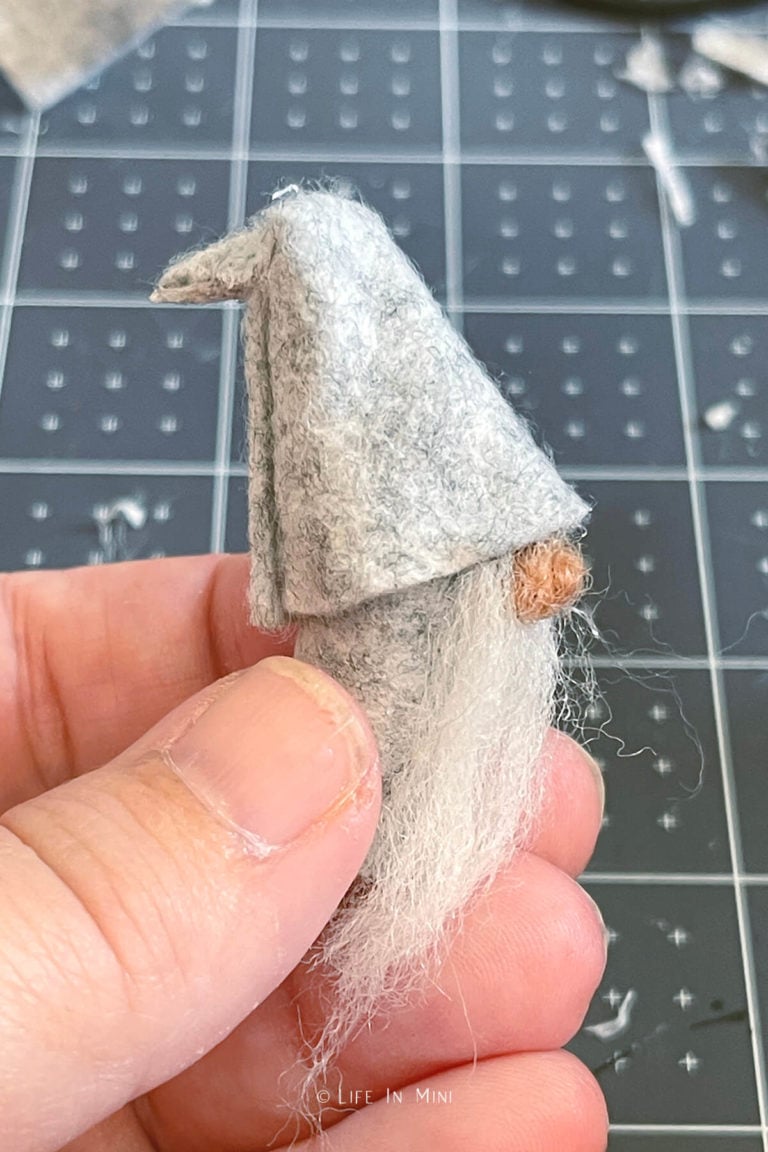 Gluing bent hat onto a halloween gnome