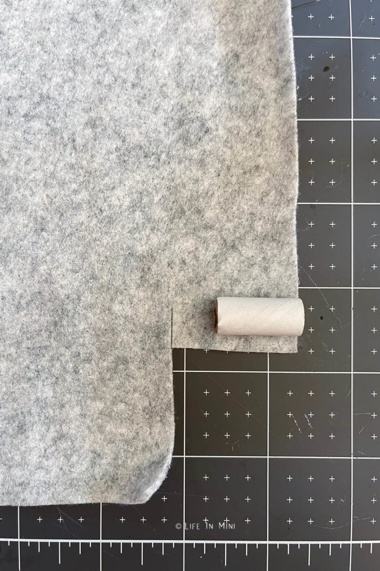 A small cardboard tube on a sheet of grey felt
