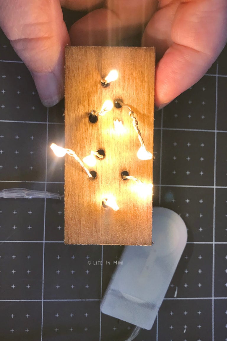Fairy lights pushed thru holes in a wooden box