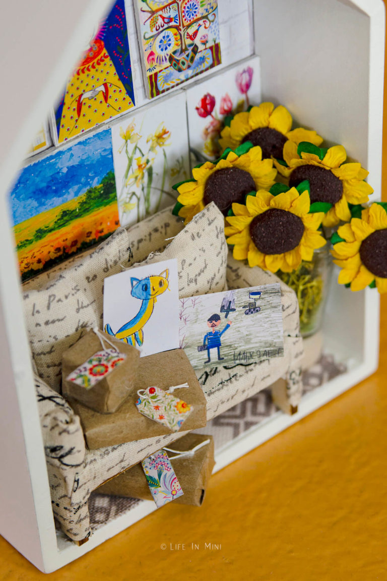Closeup of a miniature scene with small packages and artwork created by Ukrainian artists
