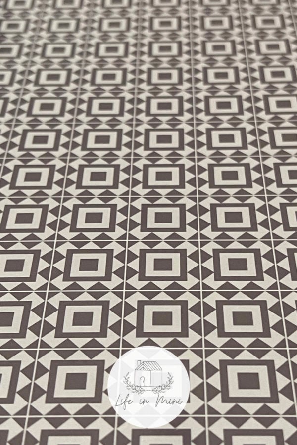 Closeup of 1:12 taupe square geometric dollhouse tile flooring