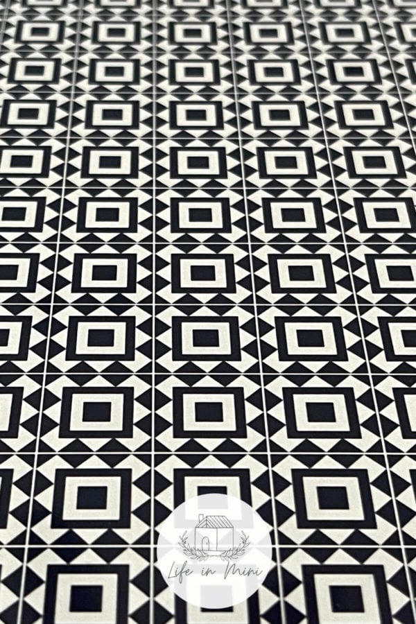 Closeup of 1:12 black square geometric dollhouse tile flooring