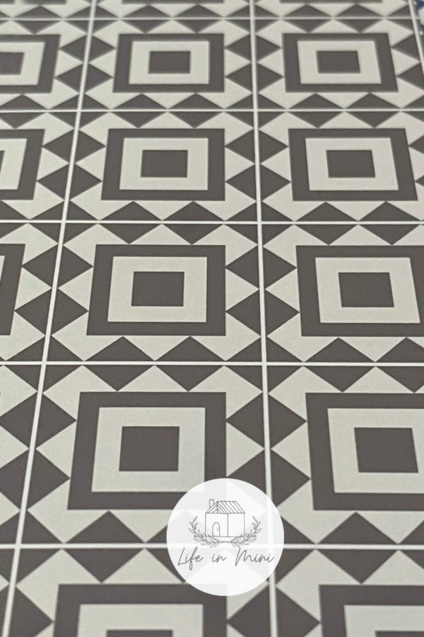 Closeup of 1:6 taupe square geometric dollhouse tile flooring