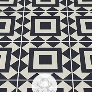 Closeup of 1:6 black square geometric dollhouse tile flooring