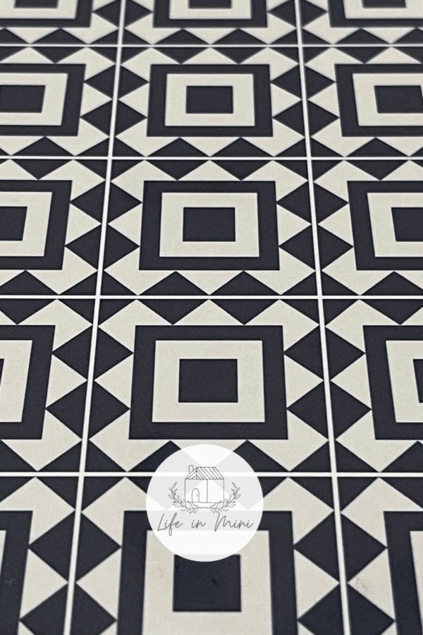 Closeup of 1:6 black square geometric dollhouse tile flooring