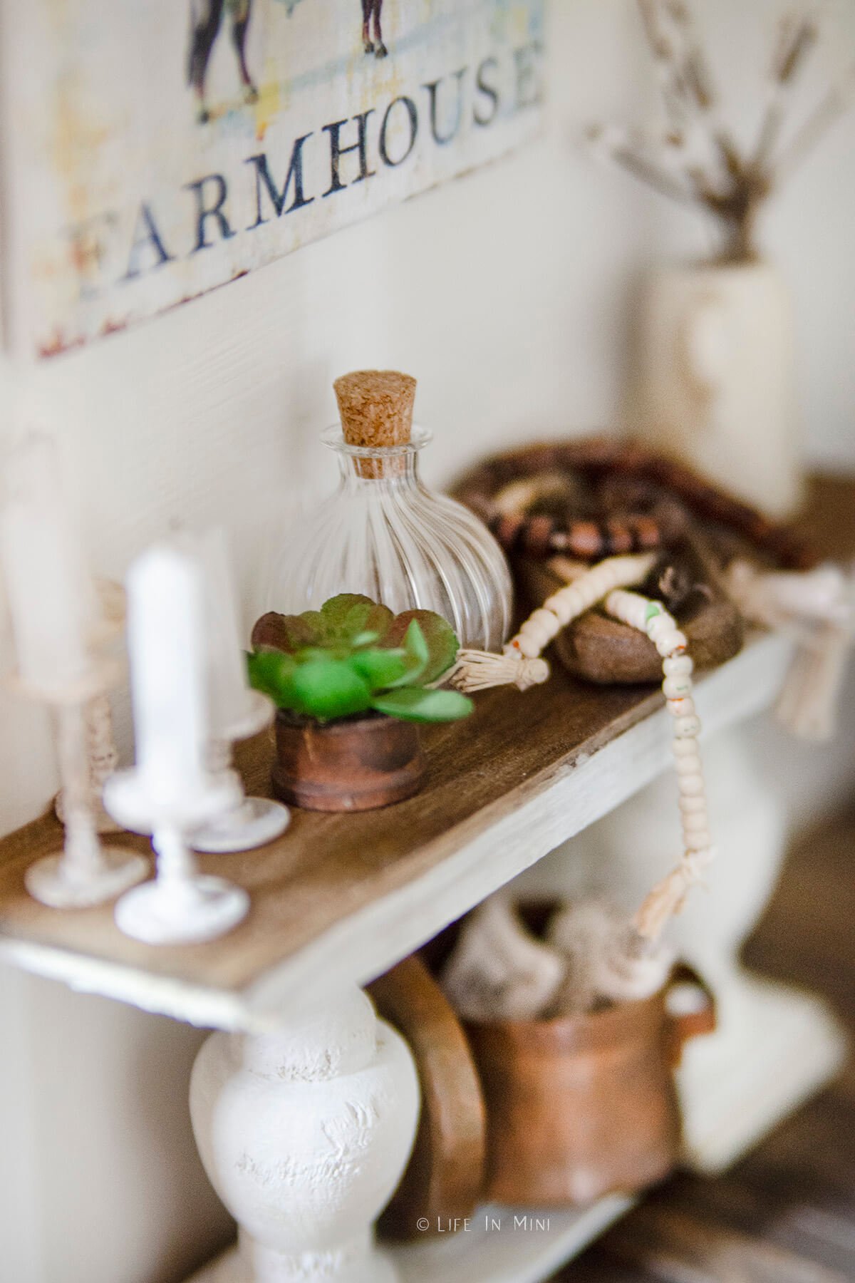 Closeup of accessories on a miniature farmhouse console table