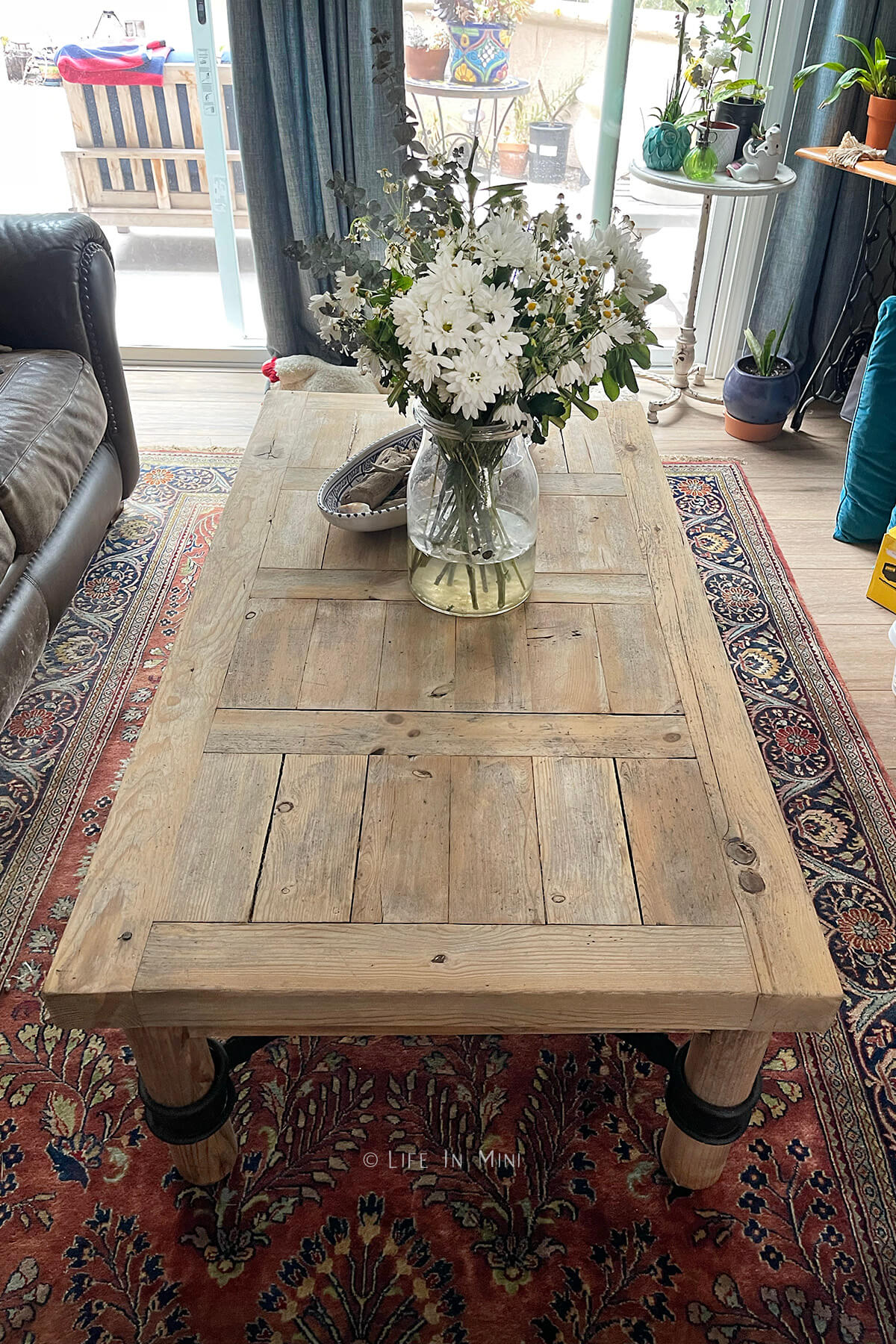 A light wood coffee table in a living room after it the wood was bleached