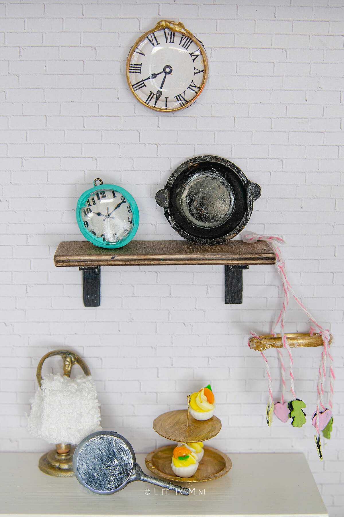 Miniature antique clocks, cast iron pan, towel ring, hand mirror, tiered tray and mobile all made with plastic pull tabs
