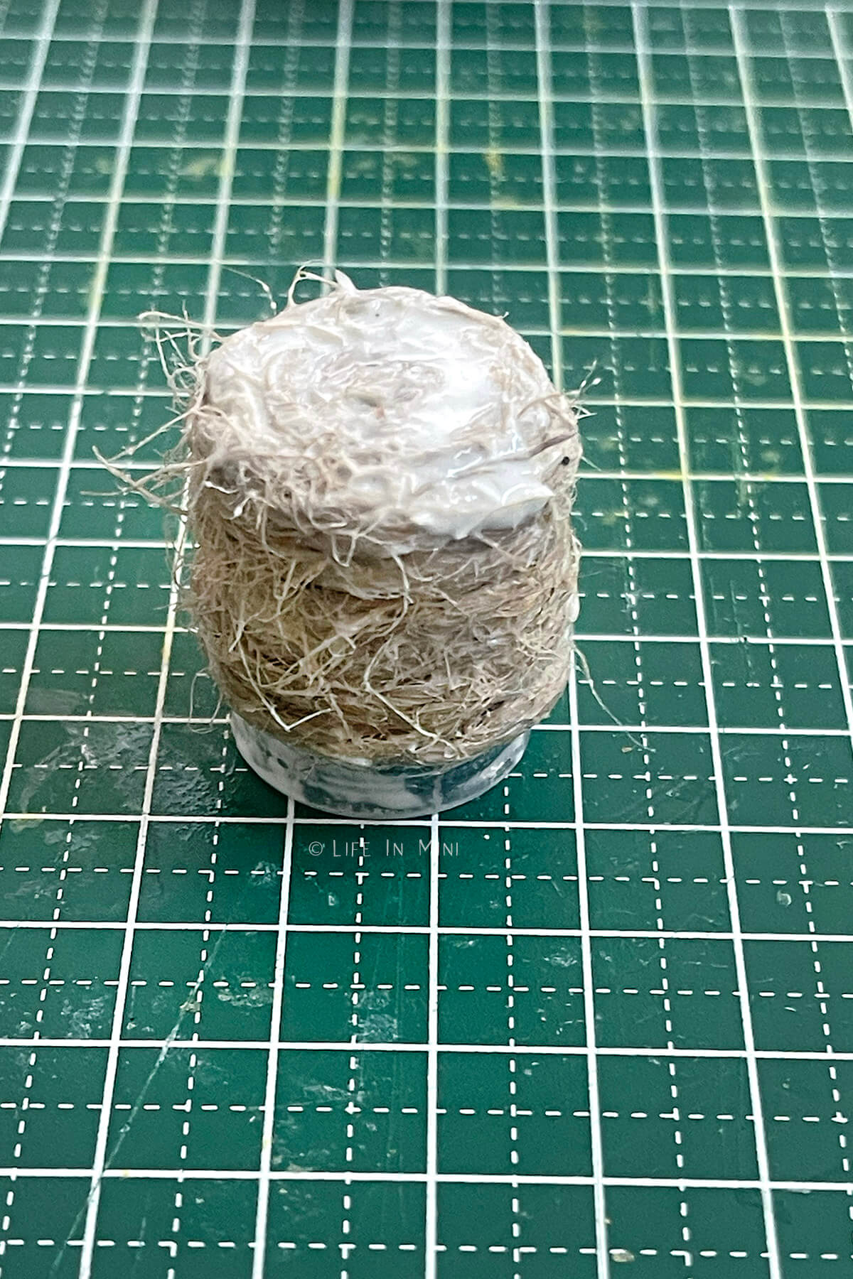 Making a small mini twin basket covered in glue on a bottle cap form