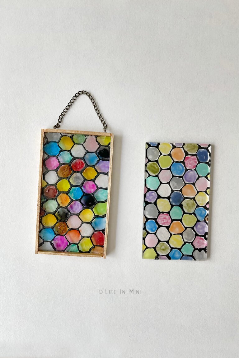 A miniature honeycomb design stained glass made with glass paint next to the same design but colored with glue mixed with paint