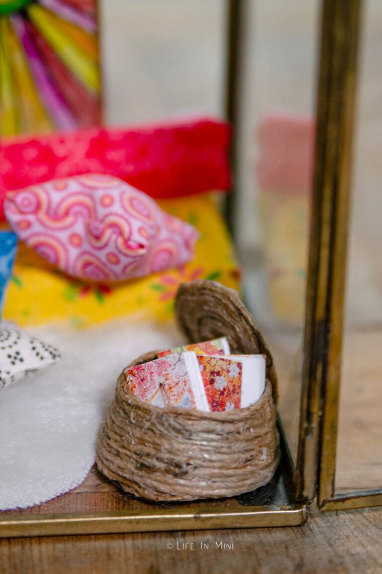 Closeup of a basket filled with colorful books in a miniature scene