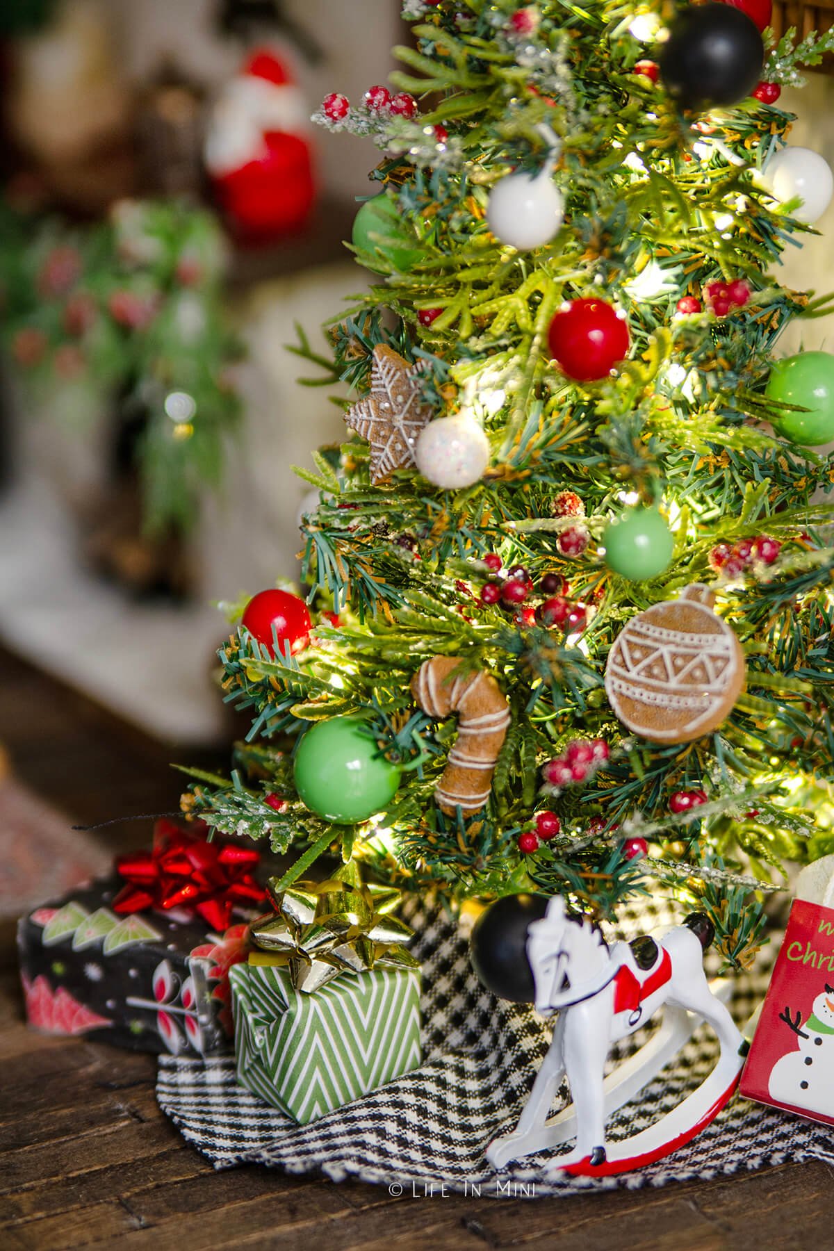 Closeup of ornaments on a dollhouse christmas tree.